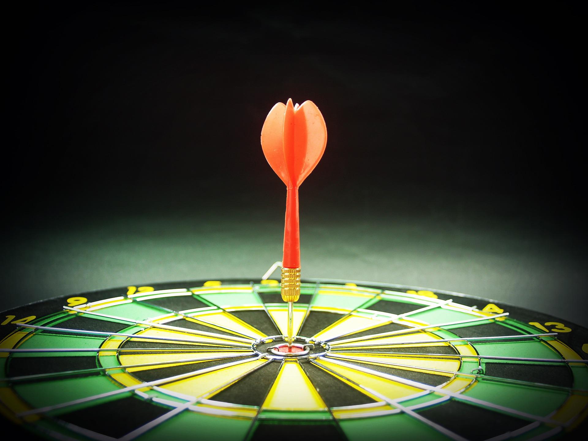 Dartboard with one dart in the bullseye, representing the precision of our keyword research services.