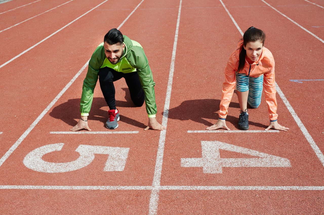A man and woman line up to sprint (metaphor for Ecommerce marketing agency services)